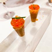 A crispy cone of brik pastry filled with salmon tartare and topped with trout roe