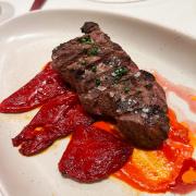 Grilled 6-oz flat iron steak with confit piquillo peppers 